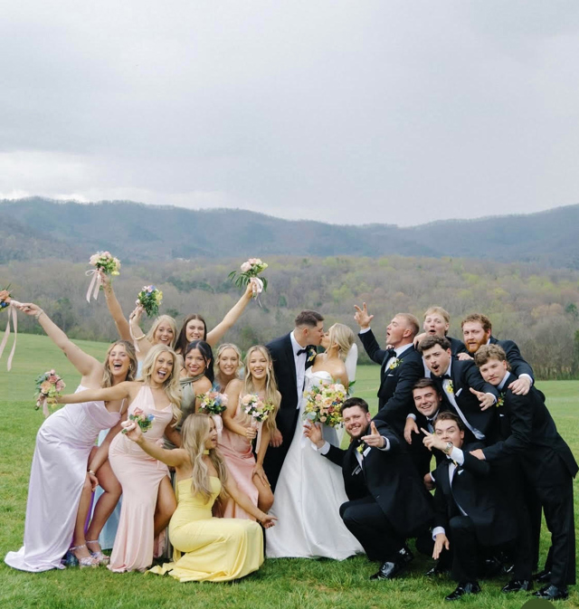 The whole wedding party together on the lawn