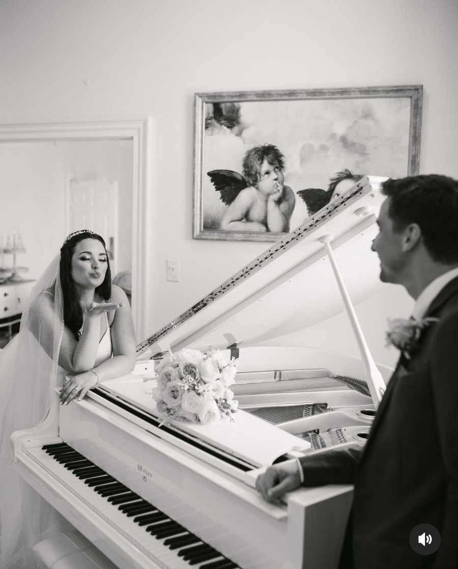The parlour on the property, tufted sofas and the white baby grand piano