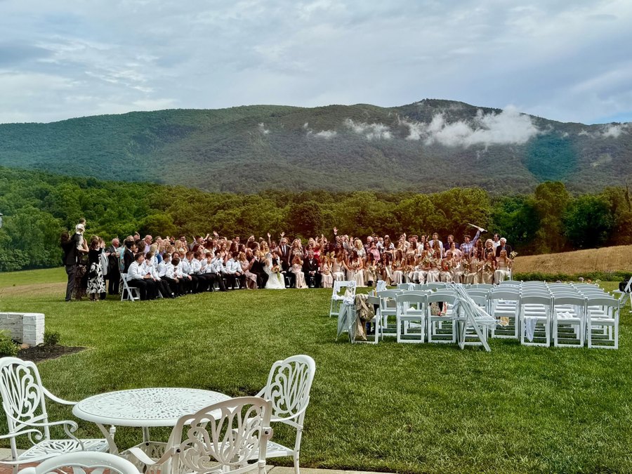 A welcome gathering on the terrace, mountains beyond